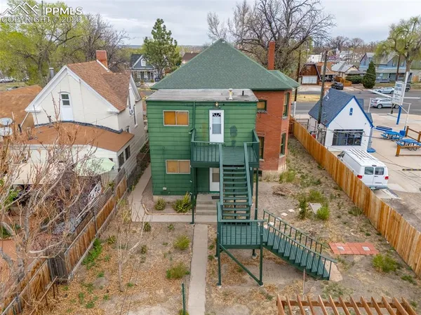 a view of a house with wooden fence