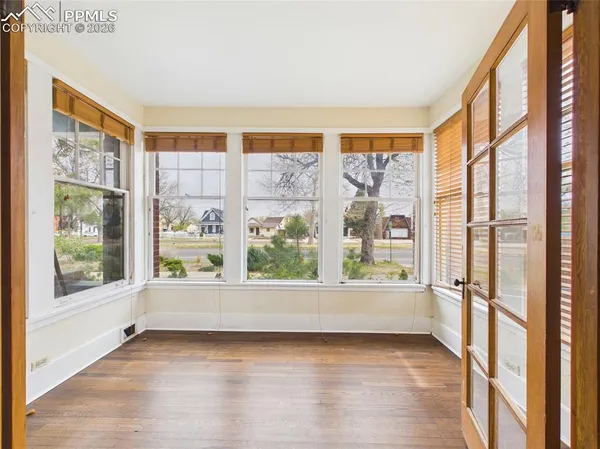 a view of wooden floor and windows in a room