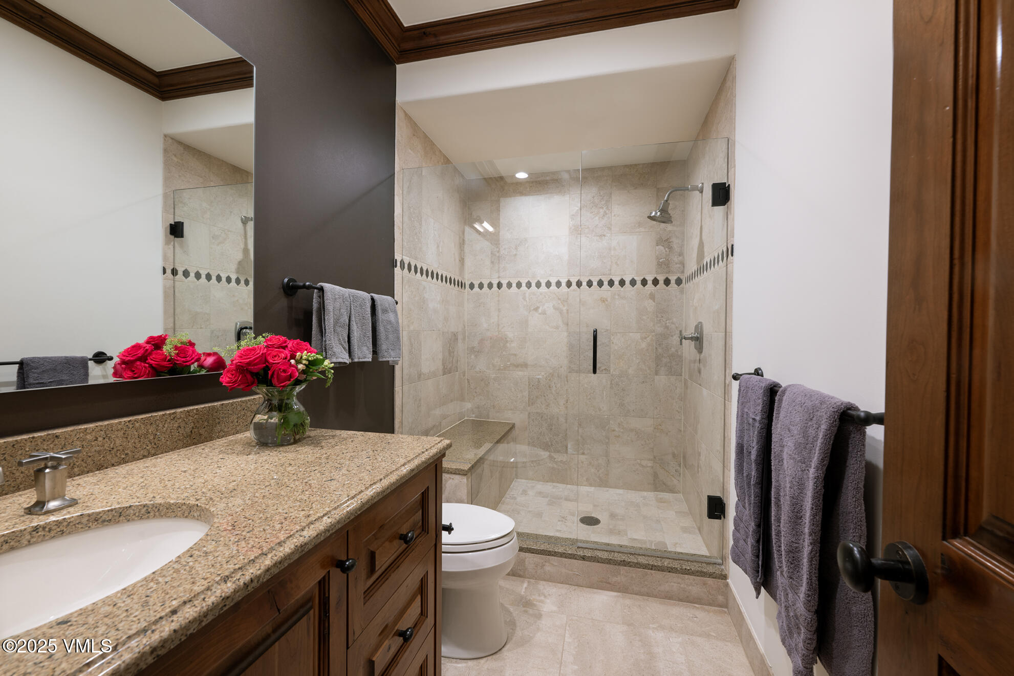185 Forest Road Vail, CO 81657 - Photo 8 of 13 a bathroom with a granite countertop shower sink vanity mirror and toilet