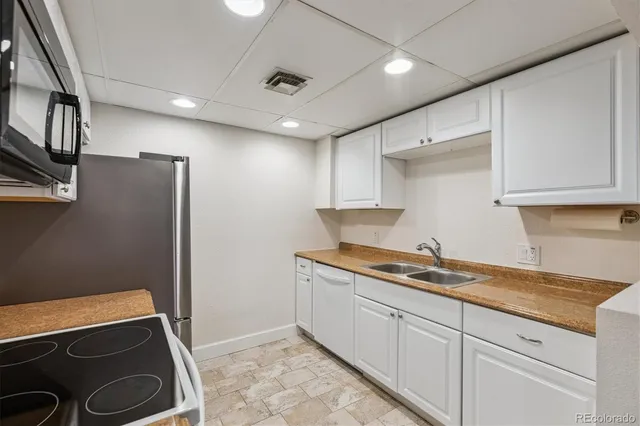 a spacious bedroom with a bed and a couch