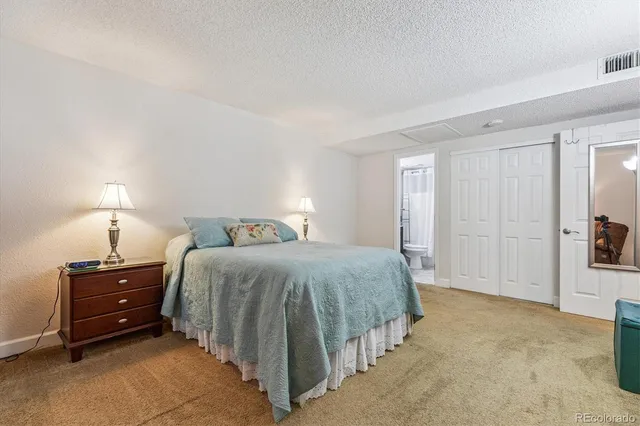 a bathroom with a granite countertop sink toilet a mirror a vanity and shower