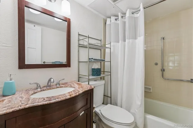 a bedroom with a bed a lamp and a large window