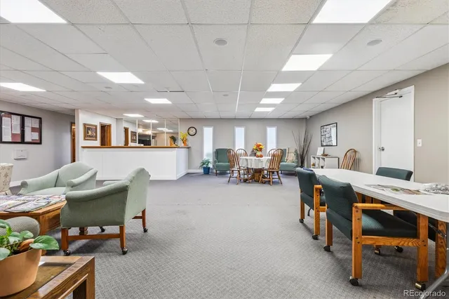 a view of a kitchen with fridge and car parked