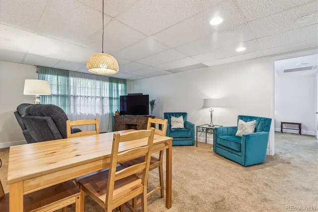 a view of a livingroom with furniture and a flat screen tv