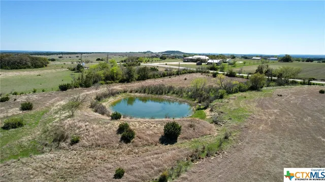 an aerial view of a houses with a yard