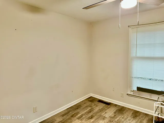 a view of a room with wooden floor