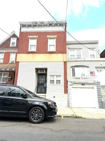 a front view of a house with parking space
