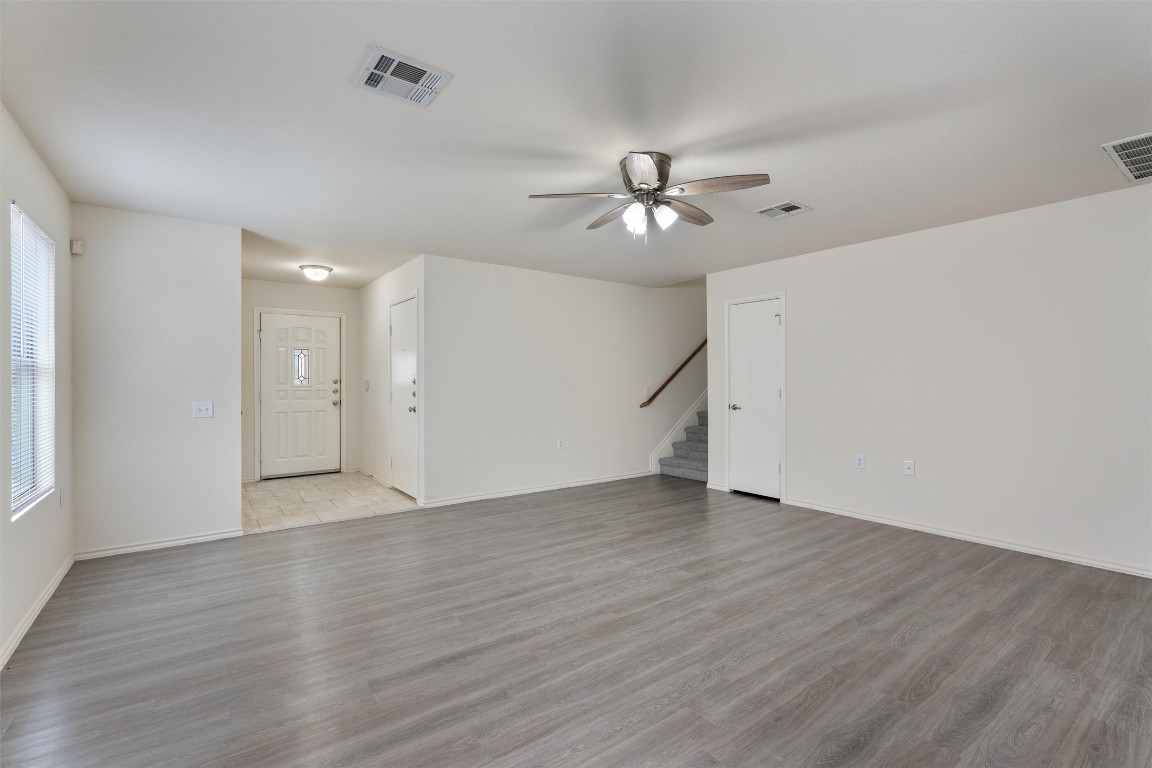 7432 Cayenne Lane Austin, TX 78741 - Photo 11 of 30 a view of empty room with wooden floor and ceiling fan