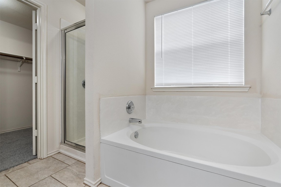 7432 Cayenne Lane Austin, TX 78741 - Photo 14 of 30 a white bath tub sitting next to a shower