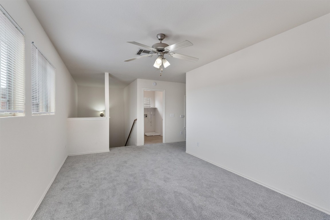7432 Cayenne Lane Austin, TX 78741 - Photo 18 of 30 a view of a big room with chandelier fan and windows
