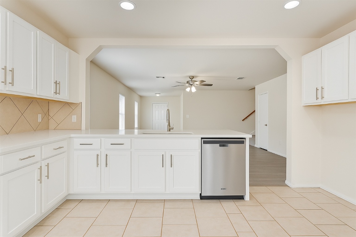 7432 Cayenne Lane Austin, TX 78741 - Photo 4 of 30 a kitchen with white cabinets