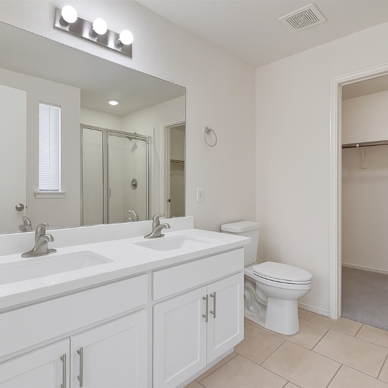 7432 Cayenne Lane Austin, TX 78741 - Photo 8 of 30 a bathroom with a toilet a sink and a mirror