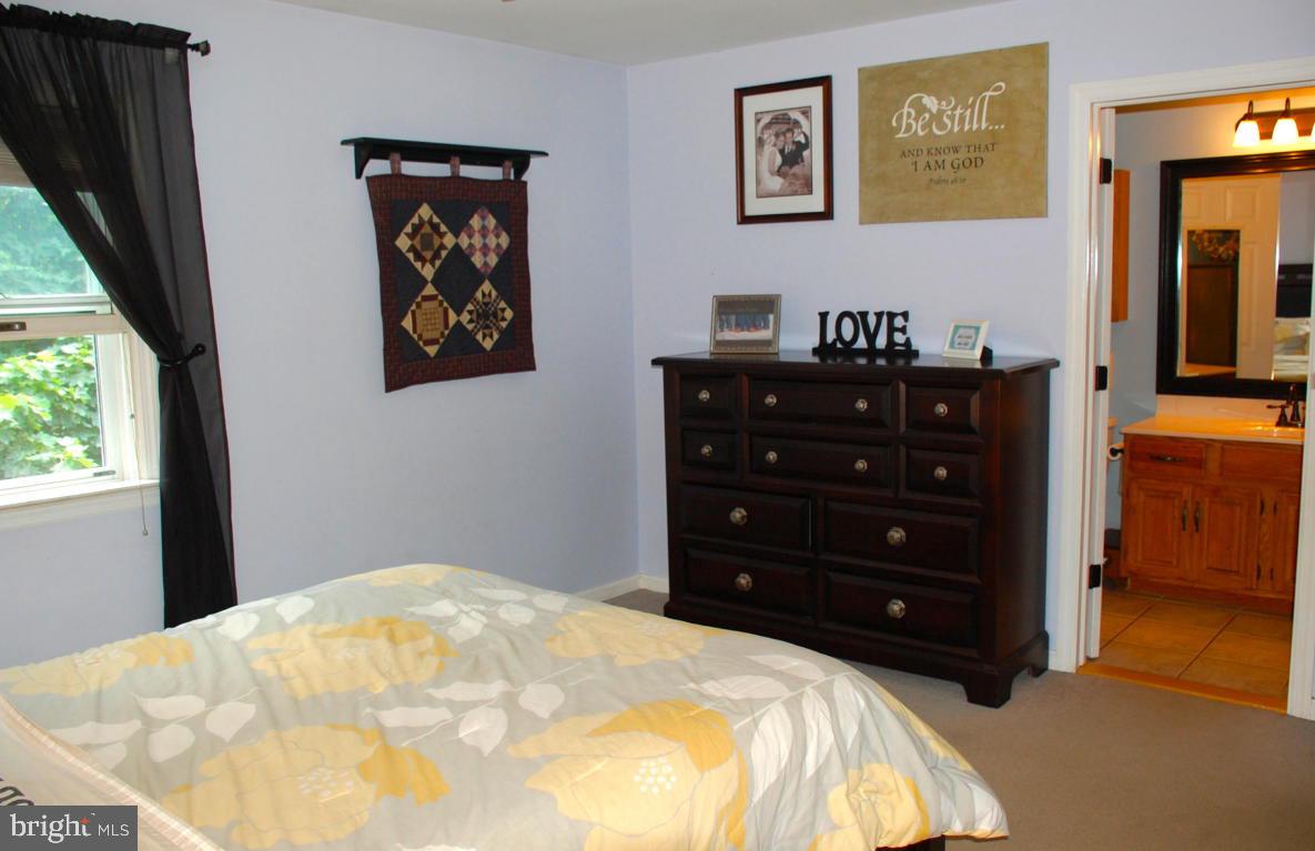 2018 Pennwick Road Lancaster, PA 17601 - Photo 8 of 16 a bedroom with a bed and a dresser
