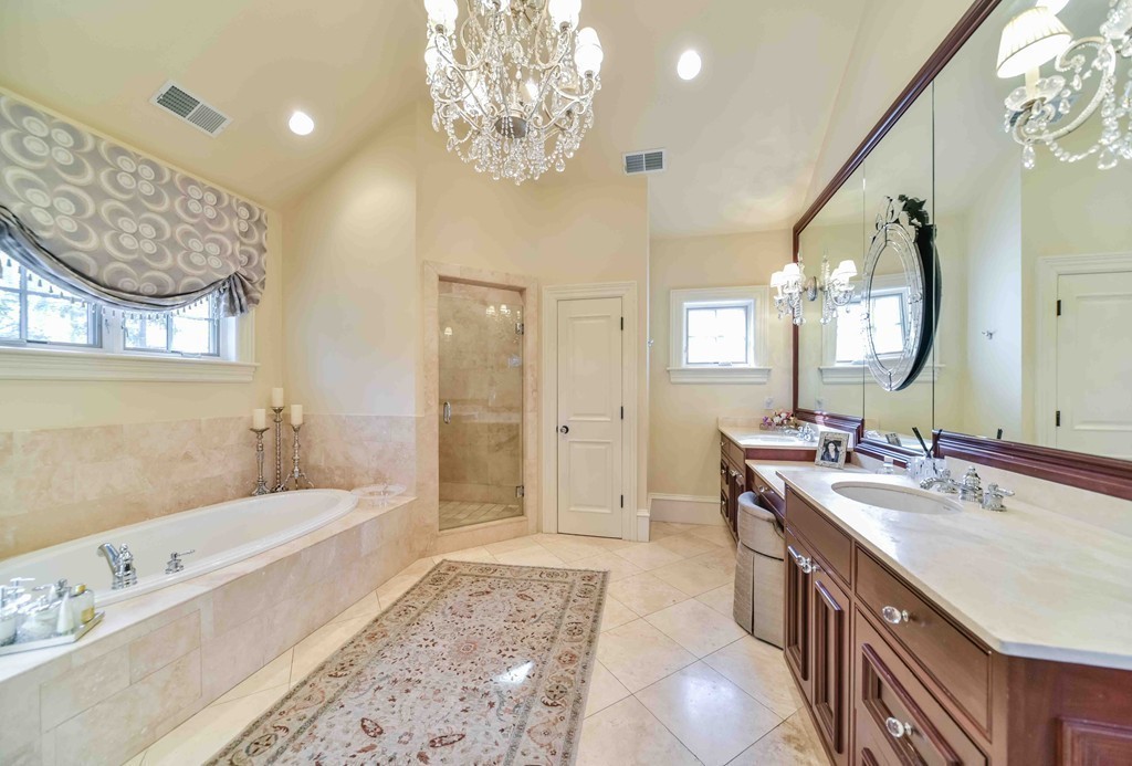 458 Heath Street Brookline, MA 02467 - Photo 18 of 28 a spacious bathroom with a tub sink and a mirror