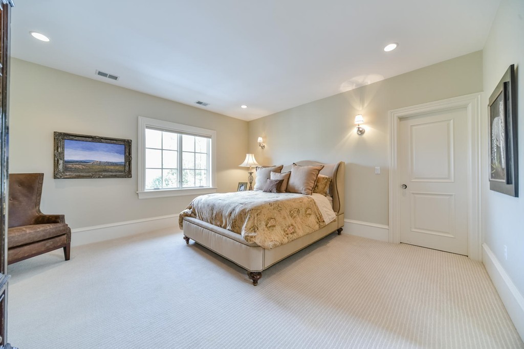 458 Heath Street Brookline, MA 02467 - Photo 20 of 28 a spacious bedroom with a bed and a couch