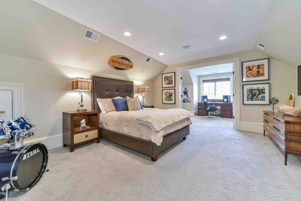 458 Heath Street Brookline, MA 02467 - Photo 21 of 28 a spacious bedroom with a bed a couch and dresser