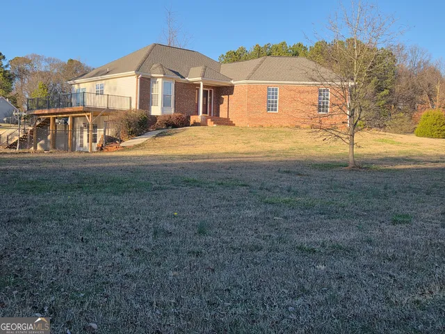 a view of an house with backyard space and balcony