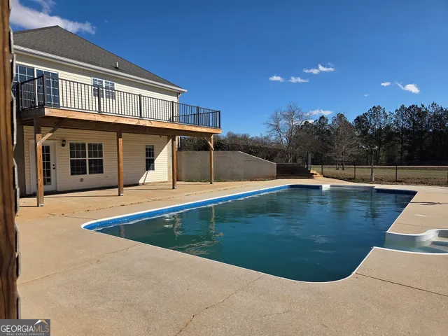 a view of a swimming pool with an outdoor seating