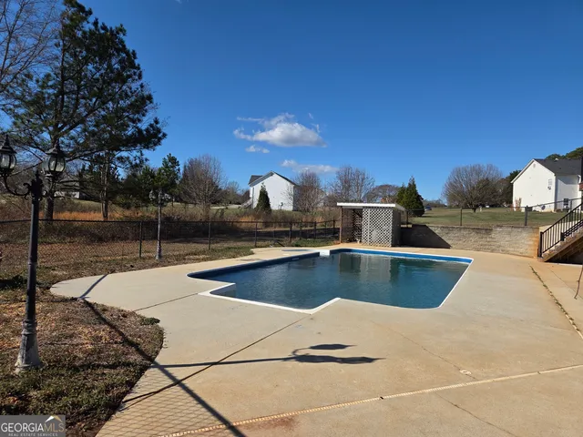 a view of a swimming pool with a lounge chairs