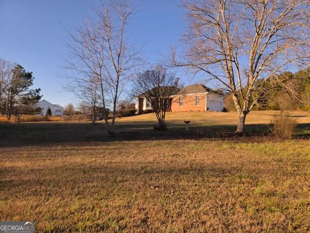a view of large yard with large trees
