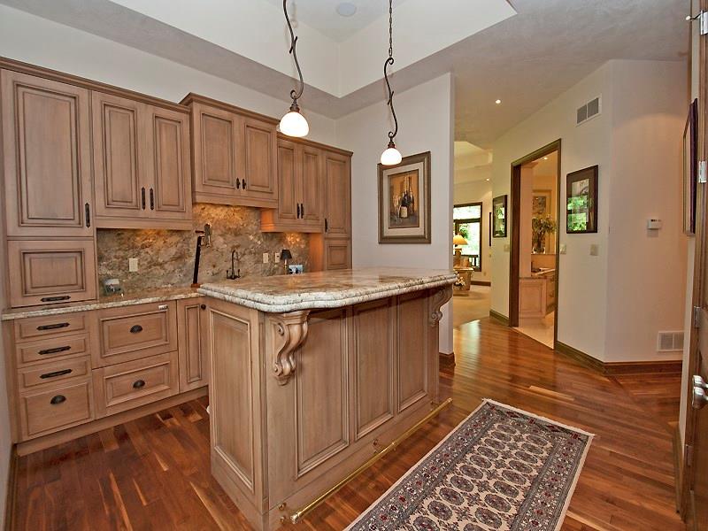 127 Hidden Valley Road Monroeville, PA 15146 - Photo 11 of 24 Open Wet Bar w/Walnut HW floors. Custom Cabinetry (William Ohs Cabinets of Denver). Granite Countertops/Backsplash (Double on Island w/Brass Foot Rail). Wet bar is located off 2nd entry on main level.