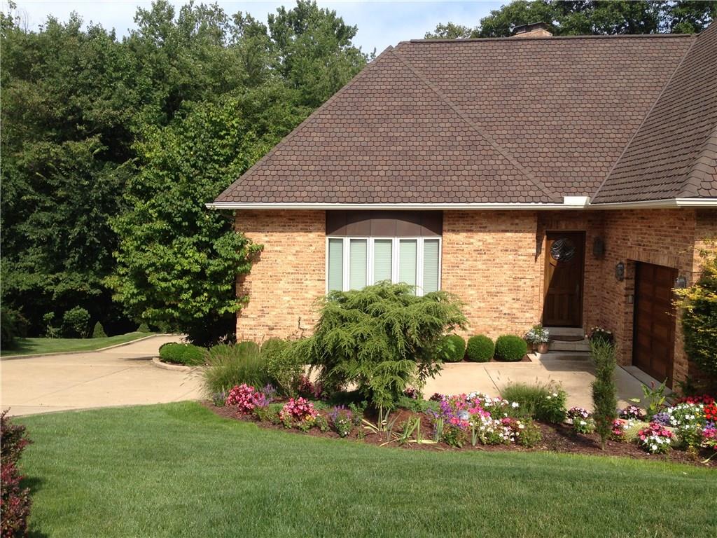127 Hidden Valley Road Monroeville, PA 15146 - Photo 3 of 24 Exterior Front: Side view shows concrete drive to attached 1 car garage and extended driveway leads to rear 4 car int/grg. This photo also shows 2nd entry that leads into open wet bar area.