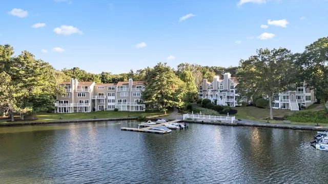 a view of residential houses with outdoor space and lake view