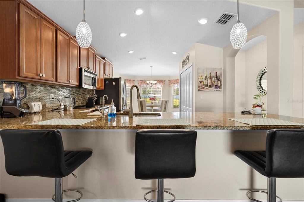 10114 Ives Loop Hudson, FL 34667 - Photo 13 of 49 a kitchen with stainless steel appliances granite countertop a sink and cabinets