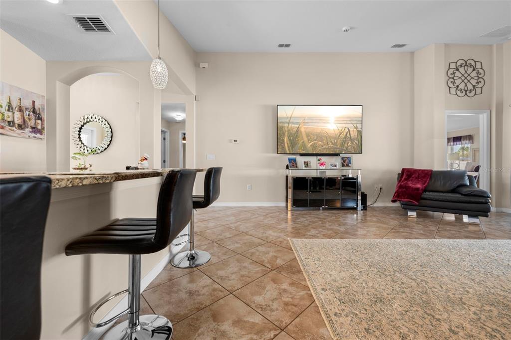 10114 Ives Loop Hudson, FL 34667 - Photo 15 of 49 a living room with furniture a flat screen tv and a table