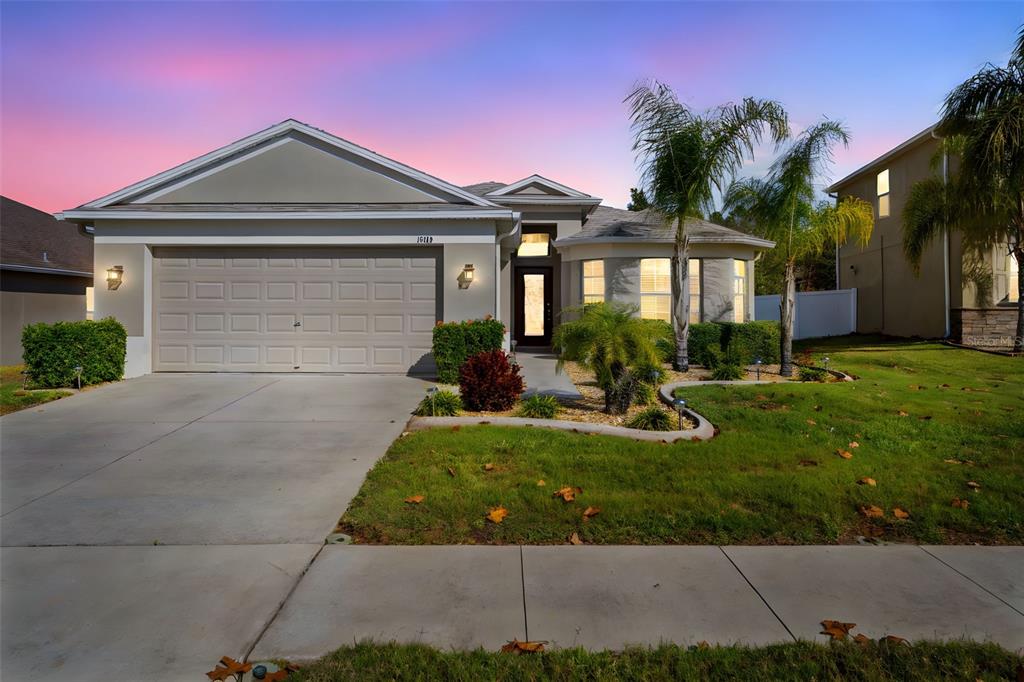 10114 Ives Loop Hudson, FL 34667 - Photo 2 of 49 a front view of a house with garden