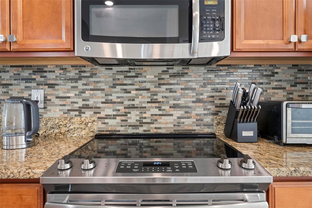 10114 Ives Loop Hudson, FL 34667 - Photo 24 of 49 a kitchen with a stove and a microwave