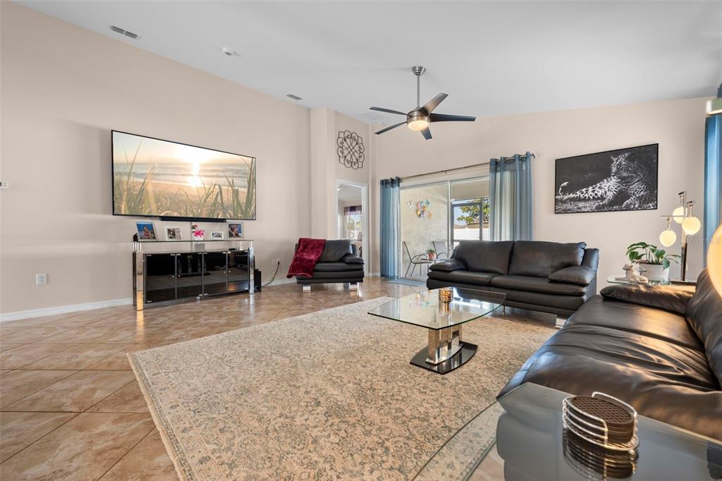 10114 Ives Loop Hudson, FL 34667 - Photo 25 of 49 a living room with furniture a fireplace and a flat screen tv