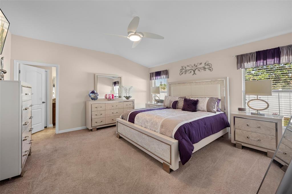 10114 Ives Loop Hudson, FL 34667 - Photo 26 of 49 a spacious bedroom with a bed and cabinets