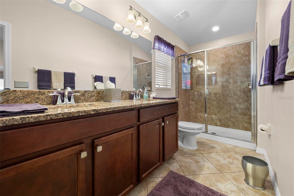 10114 Ives Loop Hudson, FL 34667 - Photo 29 of 49 a bathroom with a sink a toilet and shower