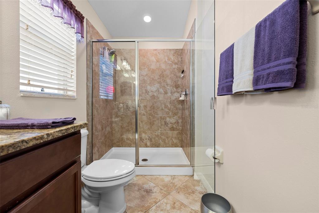 10114 Ives Loop Hudson, FL 34667 - Photo 30 of 49 a bathroom with a toilet a sink and shower