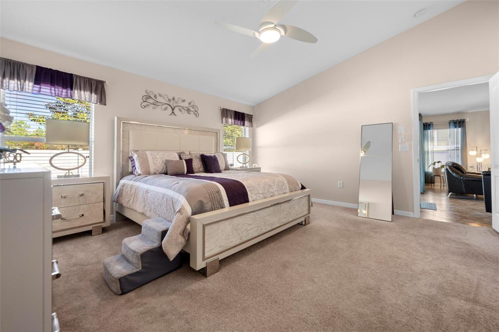 10114 Ives Loop Hudson, FL 34667 - Photo 32 of 49 a bed room with a bed and a chair