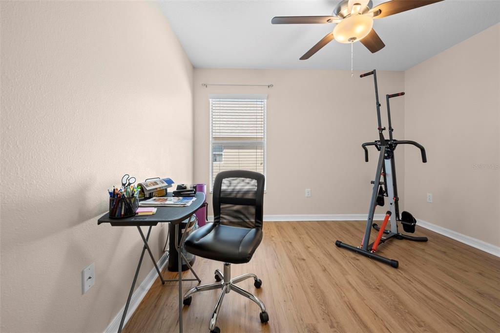 10114 Ives Loop Hudson, FL 34667 - Photo 34 of 49 a room with gym equipment and wooden floor