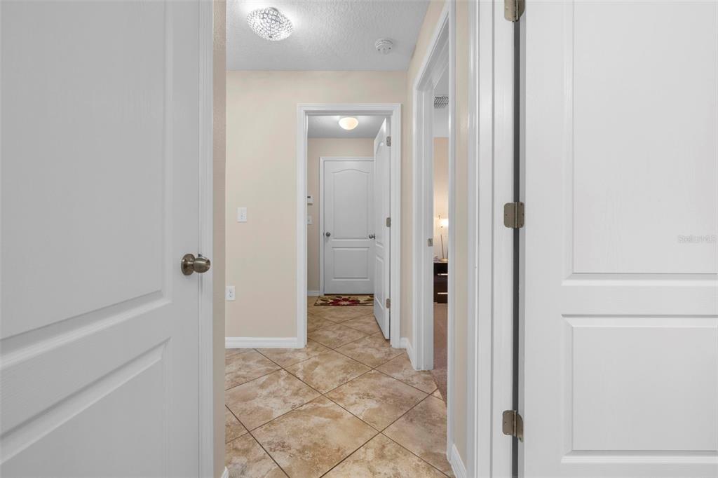10114 Ives Loop Hudson, FL 34667 - Photo 36 of 49 a view of a hallway with closet and bathroom