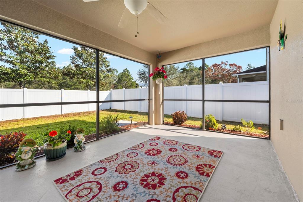 10114 Ives Loop Hudson, FL 34667 - Photo 44 of 49 a balcony with furniture and a potted plant