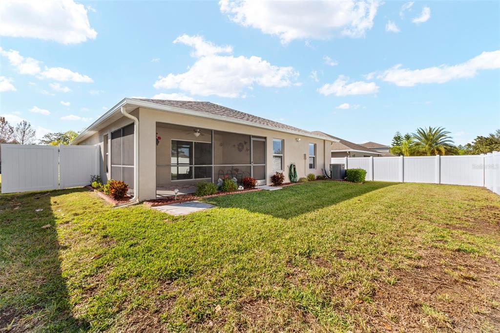 10114 Ives Loop Hudson, FL 34667 - Photo 46 of 49 a view of a house with backyard and porch