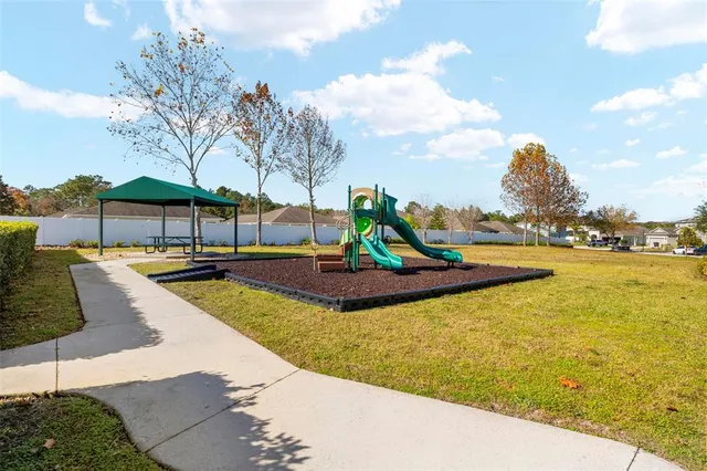 a view of swimming pool with outdoor seating and lake view