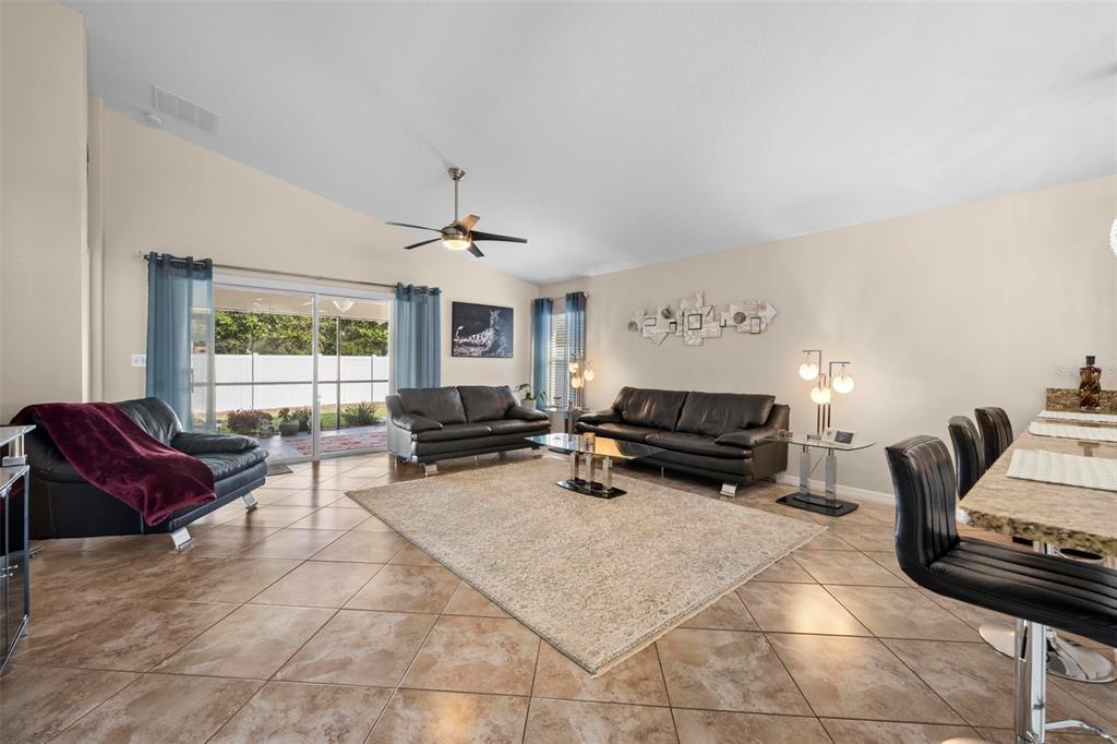 10114 Ives Loop Hudson, FL 34667 - Photo 9 of 49 a living room with furniture and a large window
