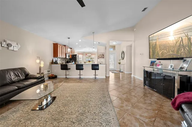 a living room with furniture and kitchen view