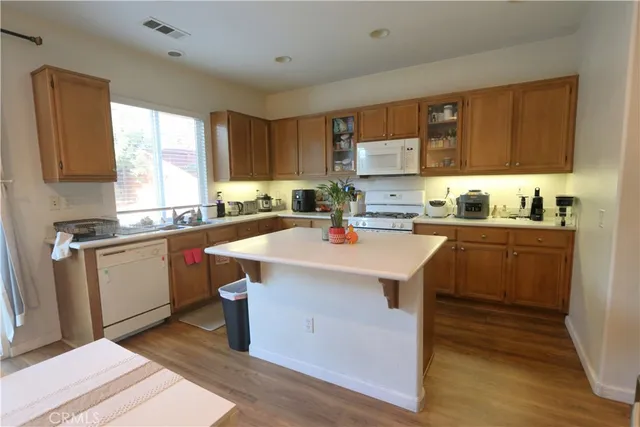 a kitchen with a sink a window and cabinets