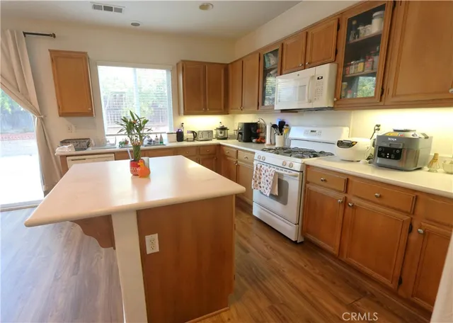 a kitchen with a sink a stove and cabinets