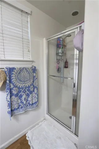 a bathroom with a glass shower door