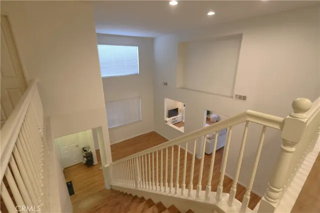 a view of a bedroom with wooden floor