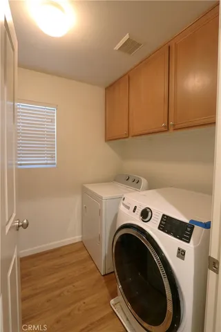 a view of washer and dryer with kitchen in the background