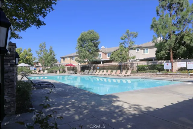 a view of a patio with table and chairs under an umbrella