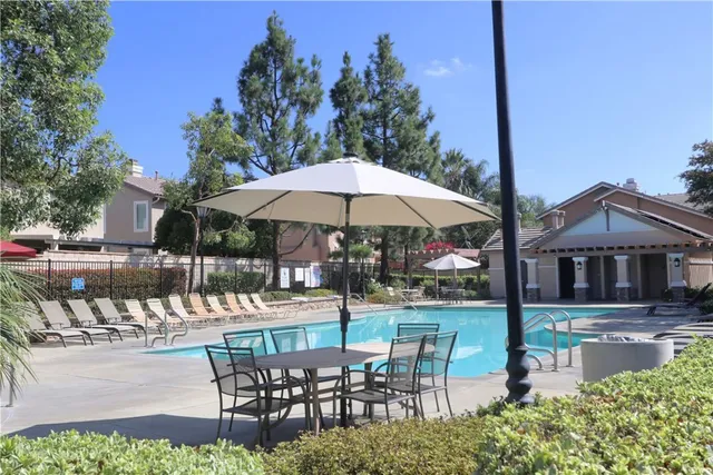 a view of a house with swimming pool and sitting area